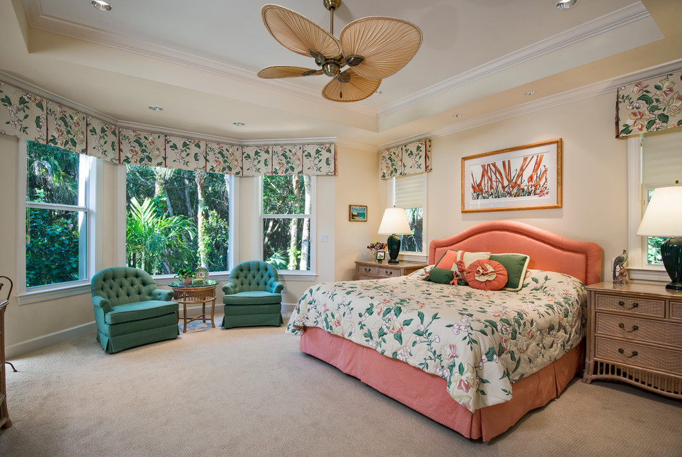 Design ideas for a traditional master bedroom in Miami with yellow walls and carpet.