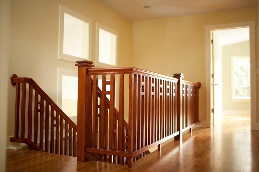 Photo of a mid-sized arts and crafts wood straight staircase in Chicago with open risers.