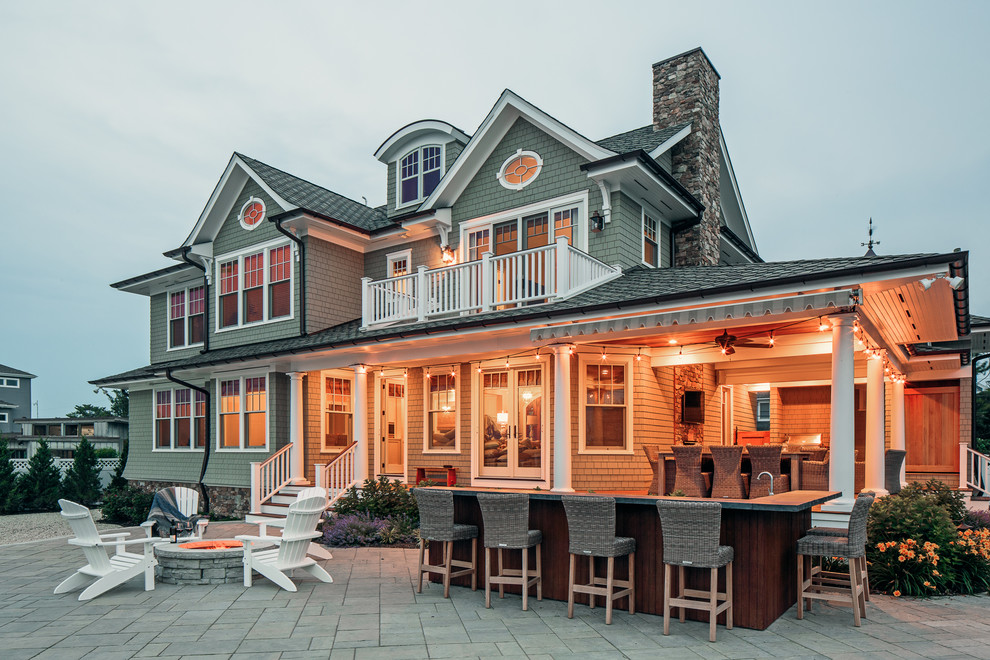 Beach style two-storey grey house exterior in New York with wood siding and a shingle roof.