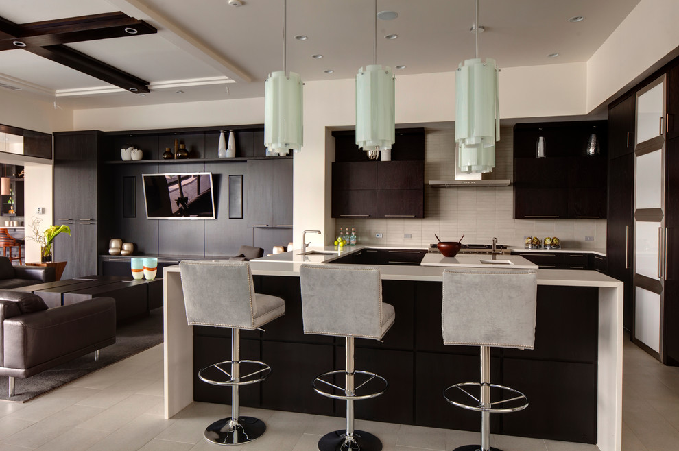 This is an example of a contemporary open plan kitchen in Orlando with an undermount sink, flat-panel cabinets, dark wood cabinets and grey splashback.
