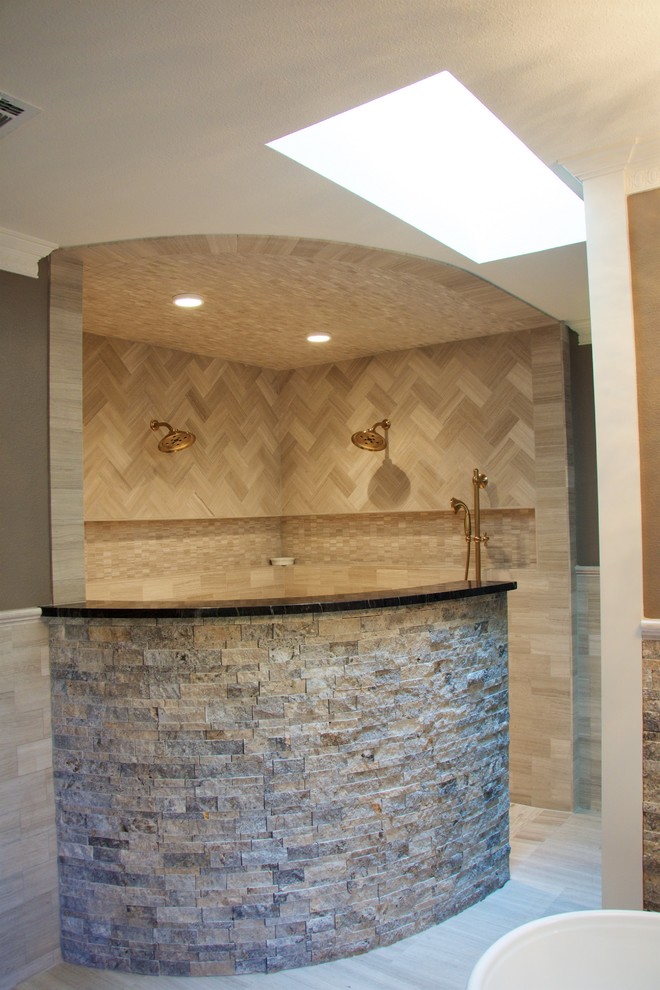 This is an example of a large contemporary master bathroom in Austin with beaded inset cabinets, dark wood cabinets, a freestanding tub, an open shower, a bidet, beige tile, beige walls, ceramic floors, a drop-in sink and granite benchtops.