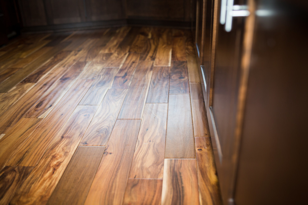 Mid-sized transitional u-shaped medium tone wood floor and brown floor enclosed kitchen photo in Omaha with shaker cabinets, dark wood cabinets, quartz countertops, white backsplash, subway tile backsplash, stainless steel appliances and a peninsula
