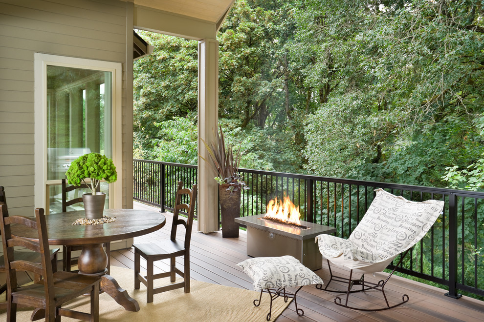 Mid-sized contemporary backyard deck in Vancouver with a fire feature and a roof extension.