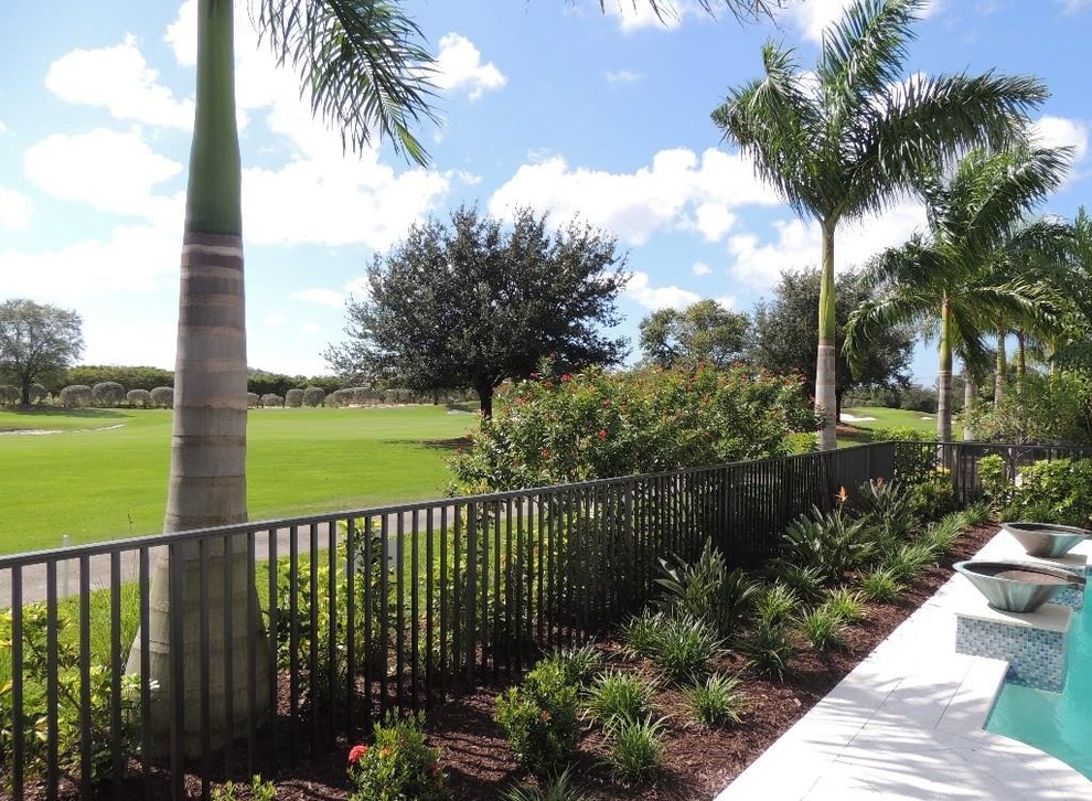 Hot tub - large transitional backyard stone and custom-shaped lap hot tub idea in Miami