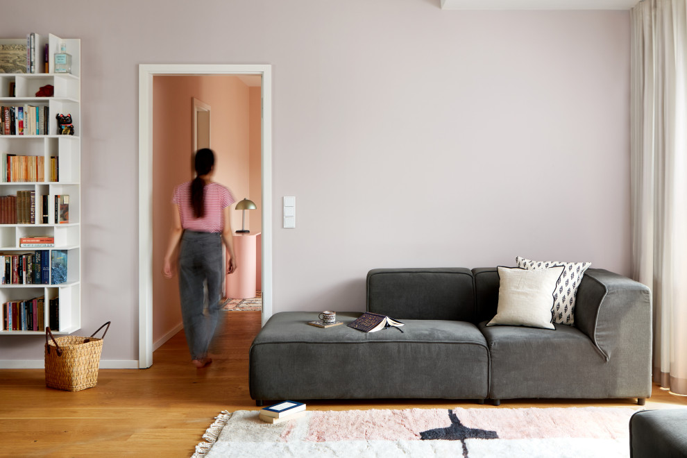 Idées déco pour un salon moderne de taille moyenne et ouvert avec un mur violet et un sol en bois brun.