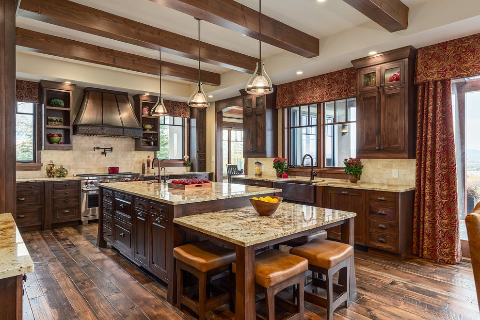 Large arts and crafts u-shaped eat-in kitchen in Calgary with a farmhouse sink, shaker cabinets, dark wood cabinets, granite benchtops, beige splashback, stone tile splashback, panelled appliances, with island and dark hardwood floors.