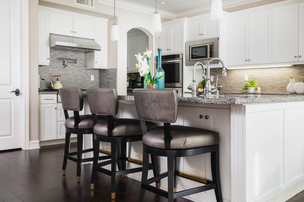 Mid-sized transitional l-shaped eat-in kitchen photo in Orange County with shaker cabinets, white cabinets, granite countertops, stainless steel appliances, an island and gray countertops