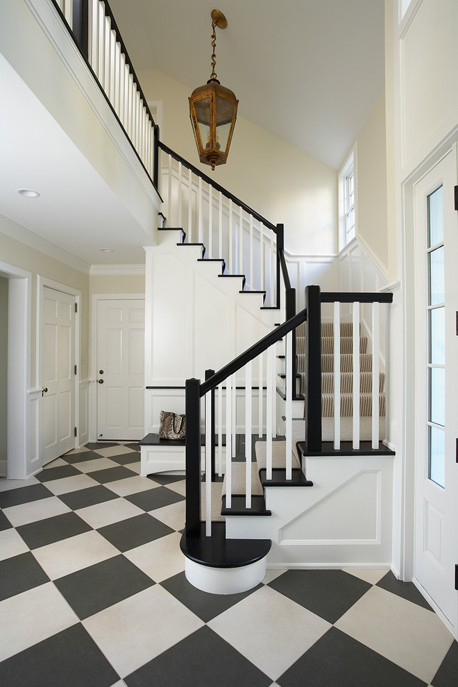 This is an example of a large traditional foyer in Minneapolis with beige walls and multi-coloured floor.