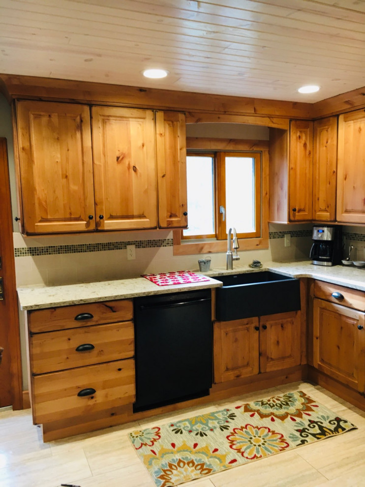Inspiration for a mid-sized rustic u-shaped enclosed kitchen remodel in Detroit with a farmhouse sink, raised-panel cabinets, light wood cabinets, quartz countertops and an island