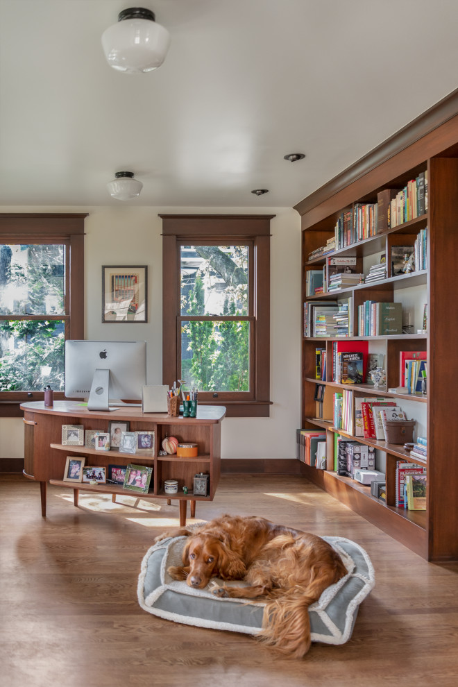 Mid-sized arts and crafts home office in Seattle with white walls, medium hardwood floors and a freestanding desk.