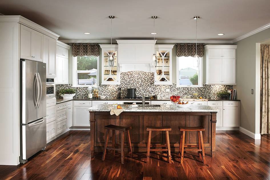Mid-sized transitional l-shaped dark wood floor and brown floor enclosed kitchen photo in New York with an undermount sink, recessed-panel cabinets, white cabinets, multicolored backsplash, mosaic tile backsplash, stainless steel appliances and an island