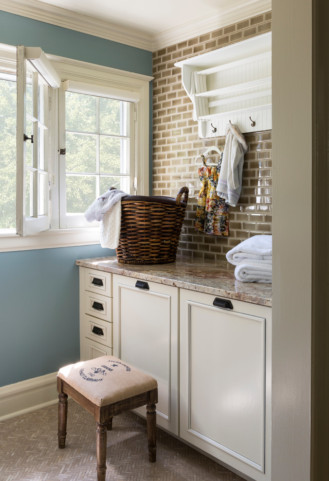 Design ideas for a mid-sized transitional galley dedicated laundry room in Denver with louvered cabinets, beige cabinets, solid surface benchtops, blue walls, ceramic floors, beige floor and beige benchtop.