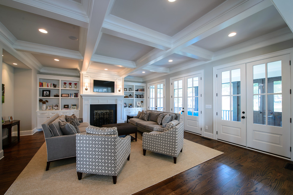 Large traditional open concept living room in Nashville with grey walls, medium hardwood floors, a standard fireplace, a stone fireplace surround and a wall-mounted tv.
