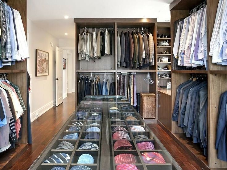 Photo of a large traditional men's walk-in wardrobe in Los Angeles with flat-panel cabinets, medium wood cabinets and dark hardwood floors.