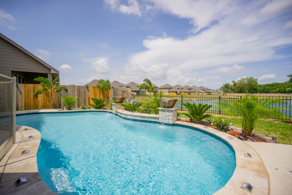Photo of a small tropical backyard kidney-shaped pool in Houston.