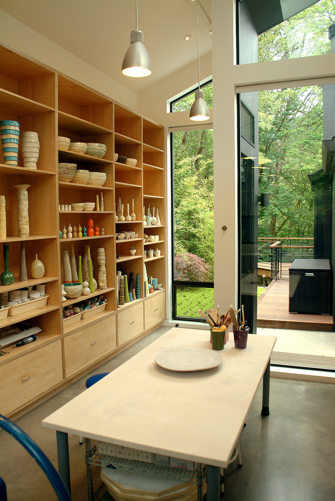 Photo of a contemporary home studio in Portland with a freestanding desk.