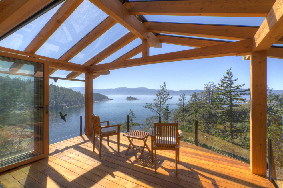 Design ideas for a country deck in Vancouver with a roof extension.