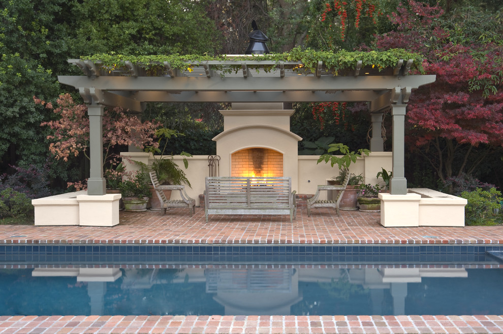 Inspiration for a traditional rectangular pool in San Francisco with brick pavers.