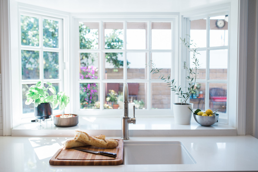 Example of a small transitional galley porcelain tile and beige floor open concept kitchen design in Orange County with a double-bowl sink, shaker cabinets, beige cabinets, quartz countertops, white backsplash, subway tile backsplash, stainless steel appliances, no island and white countertops