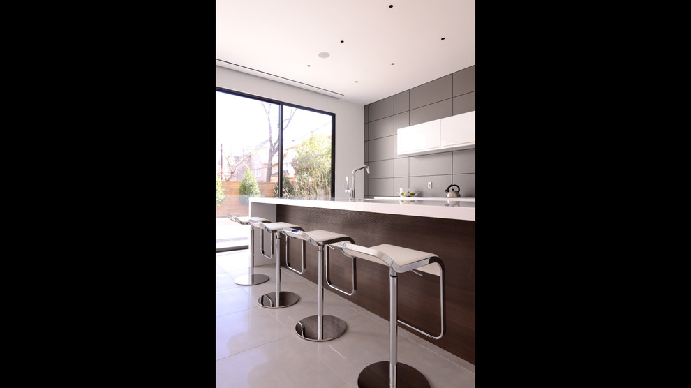 Inspiration for a large modern u-shaped ceramic tile open concept kitchen remodel in Houston with flat-panel cabinets, white cabinets, granite countertops, gray backsplash, stainless steel appliances, white walls and an island