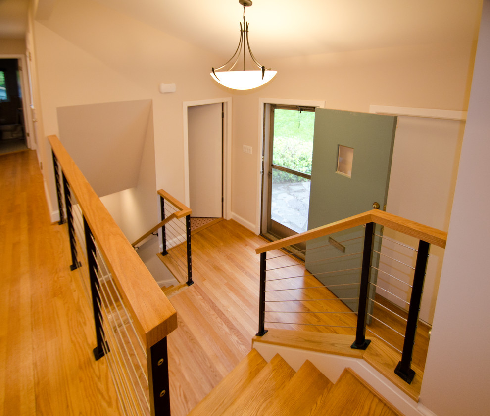 Inspiration for a mid-sized modern foyer in DC Metro with beige walls and light hardwood floors.