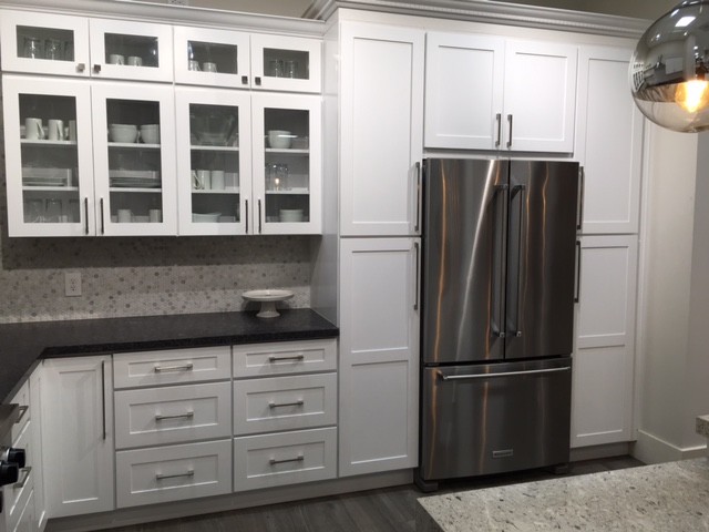 Inspiration for a mid-sized transitional l-shaped dark wood floor and gray floor enclosed kitchen remodel in Orange County with white cabinets, gray backsplash, mosaic tile backsplash, stainless steel appliances, shaker cabinets, granite countertops and an island