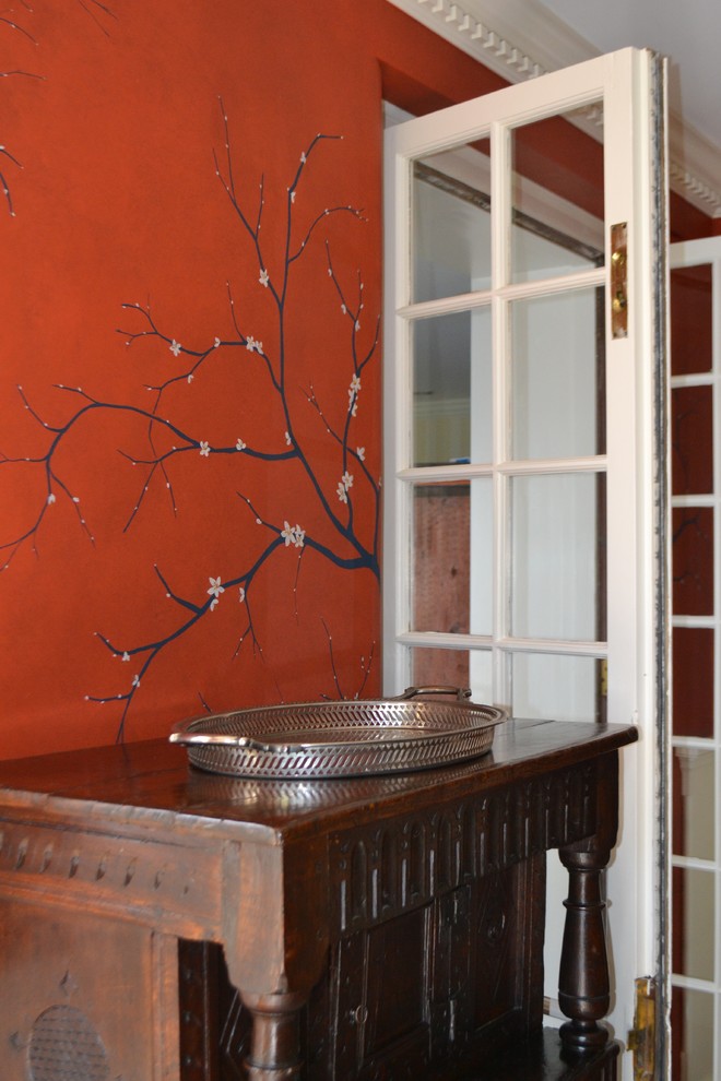 Design ideas for a country separate dining room in Philadelphia with red walls.