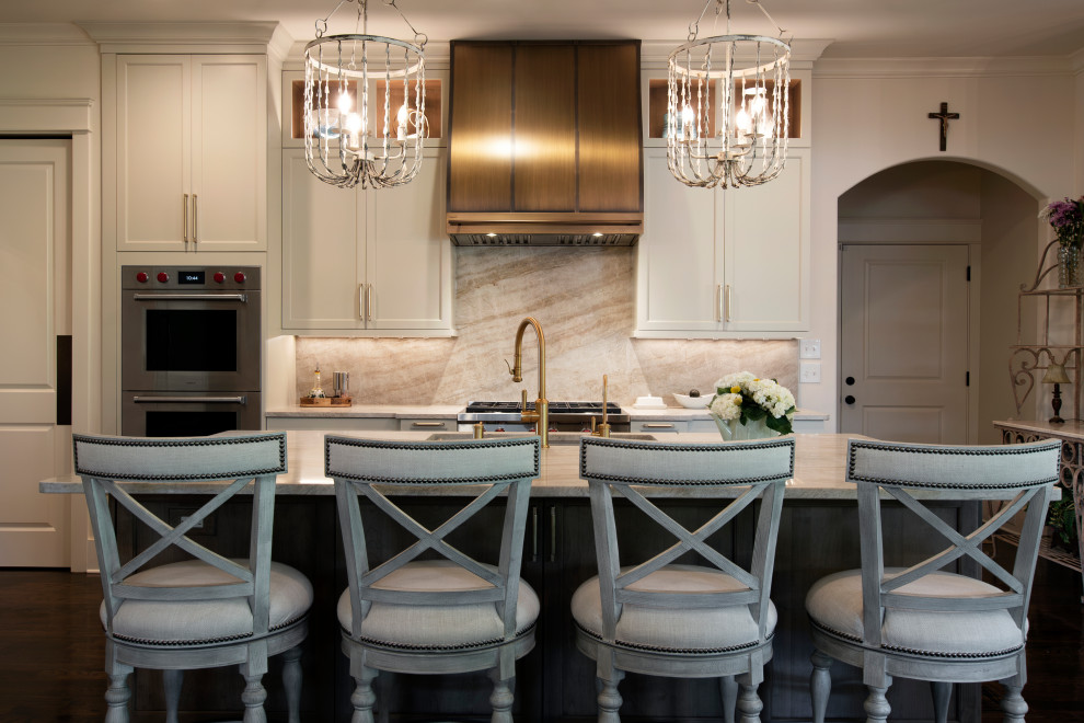 Open concept kitchen - large transitional l-shaped dark wood floor and brown floor open concept kitchen idea in Nashville with an undermount sink, beaded inset cabinets, white cabinets, quartzite countertops, beige backsplash, stone slab backsplash, stainless steel appliances, an island and beige countertops