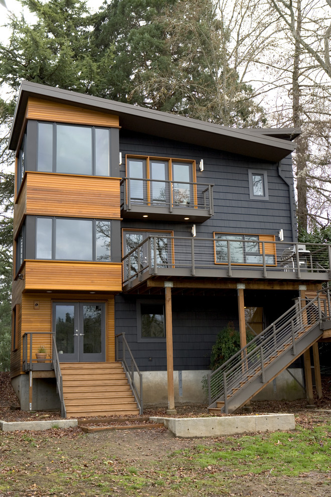 Inspiration for a contemporary three-storey exterior in Portland.