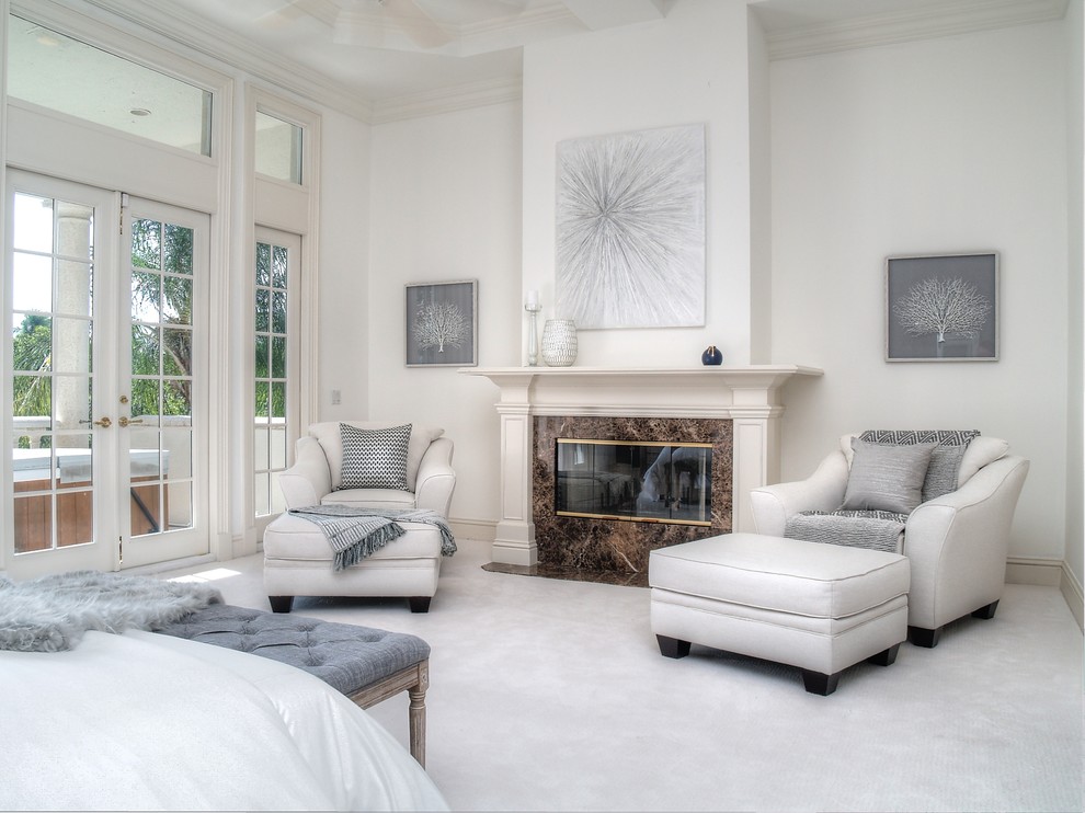 Inspiration for a transitional bedroom in Miami with beige walls, carpet, a standard fireplace and beige floor.