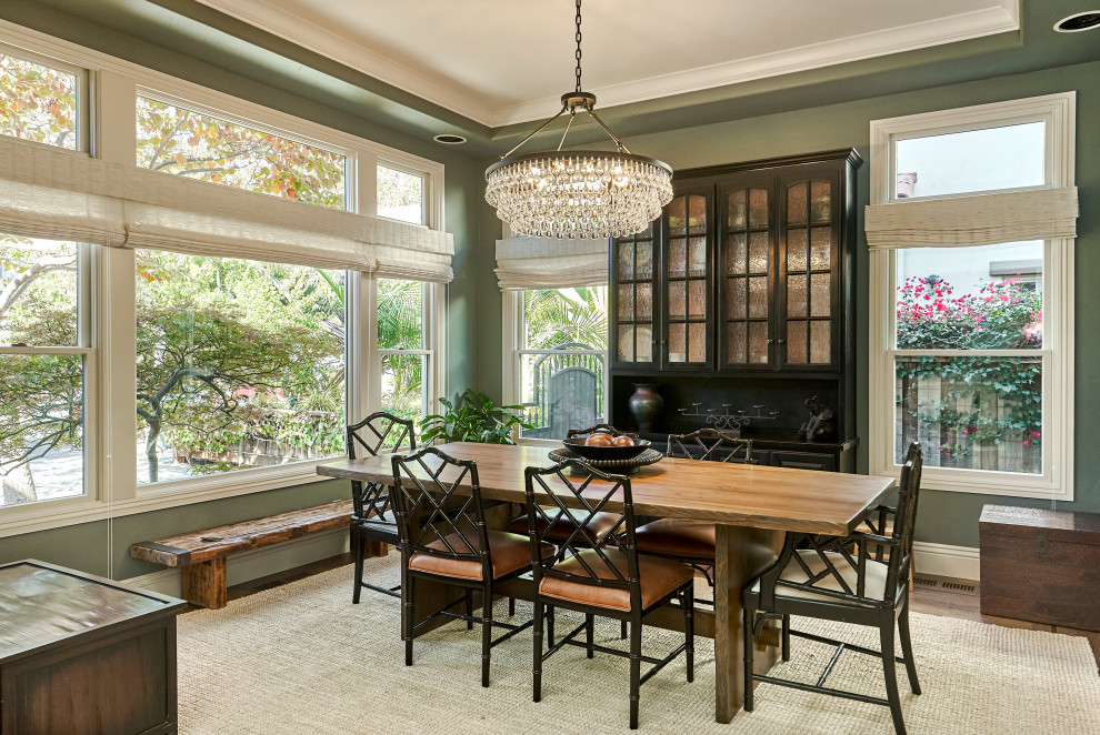 Enclosed dining room - mid-sized traditional medium tone wood floor, brown floor and tray ceiling enclosed dining room idea in San Francisco with green walls