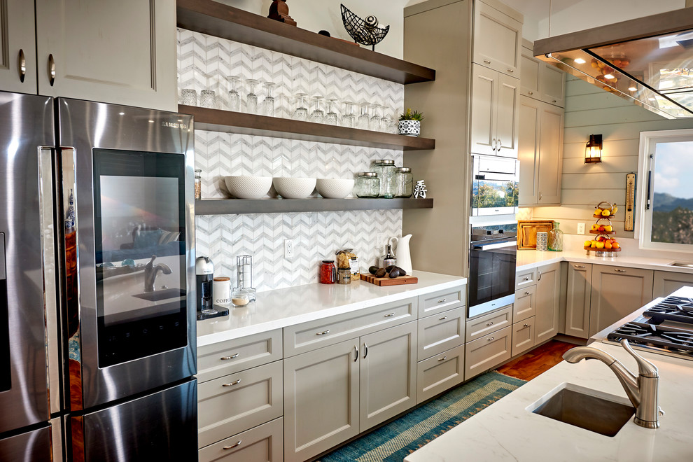 Large transitional l-shaped medium tone wood floor and brown floor open concept kitchen photo in Denver with an undermount sink, recessed-panel cabinets, gray cabinets, quartz countertops, white backsplash, marble backsplash, stainless steel appliances, an island and white countertops