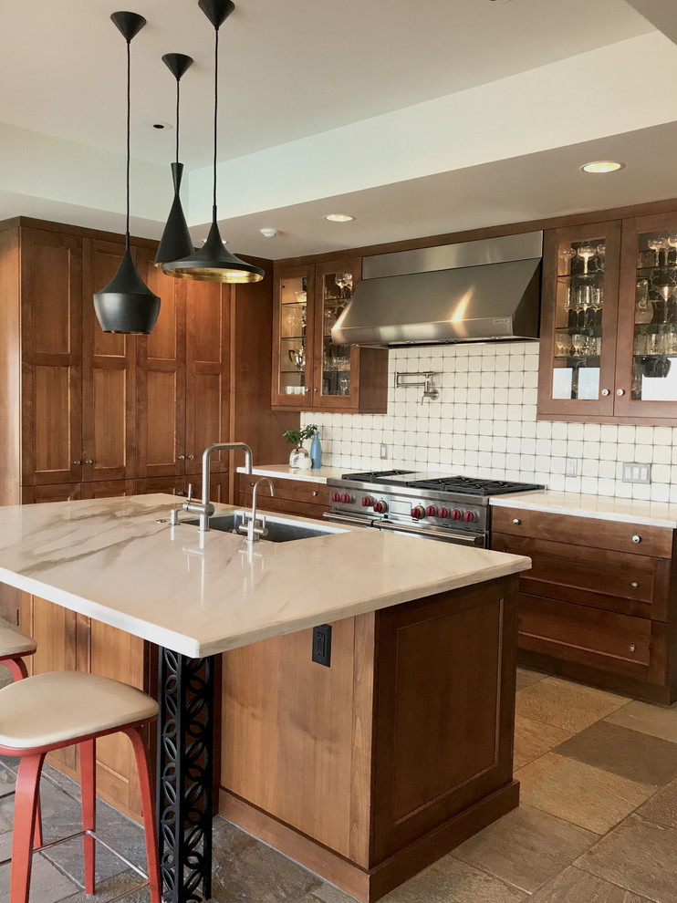 Photo of a midcentury kitchen in Los Angeles with an undermount sink, shaker cabinets, dark wood cabinets, marble benchtops, white splashback, ceramic splashback, stainless steel appliances, slate floors and with island.