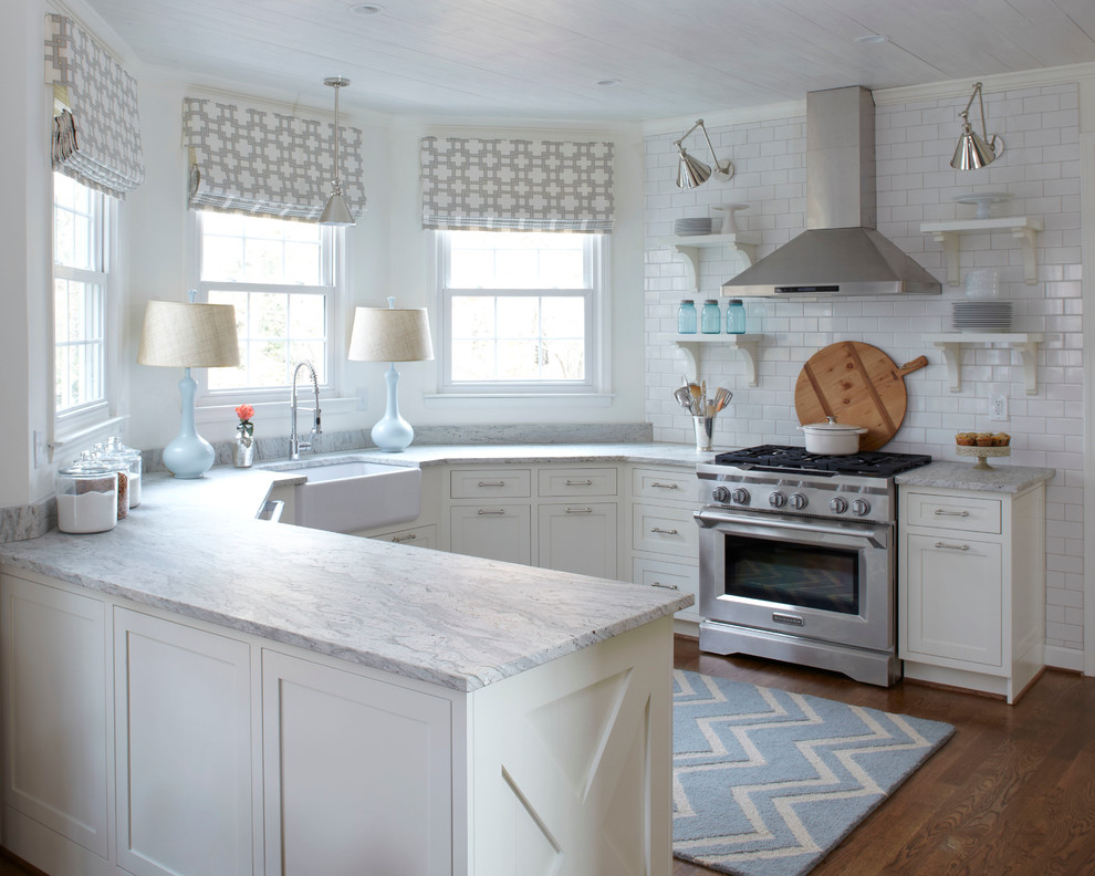 Transitional u-shaped eat-in kitchen in Atlanta with a farmhouse sink, shaker cabinets, white cabinets, white splashback, subway tile splashback, stainless steel appliances and granite benchtops.