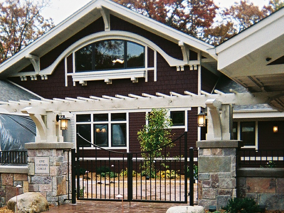 Design ideas for a large arts and crafts two-storey brown exterior in Minneapolis with wood siding and a gable roof.