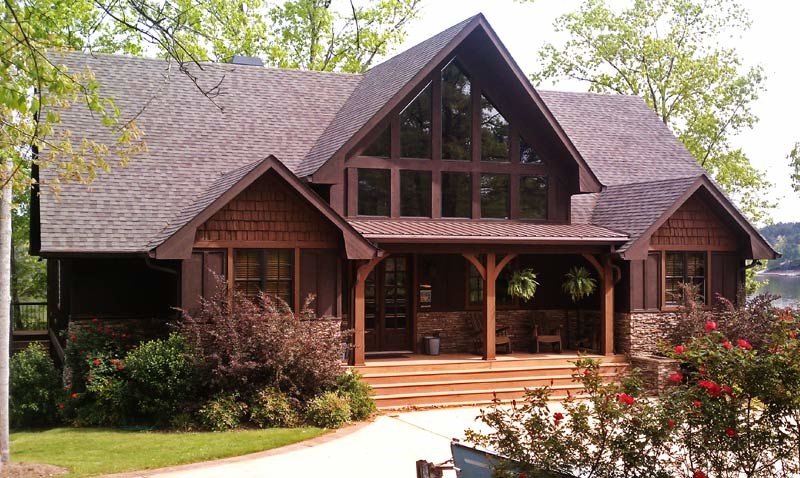 This is an example of a mid-sized country two-storey brown exterior in Atlanta with mixed siding.