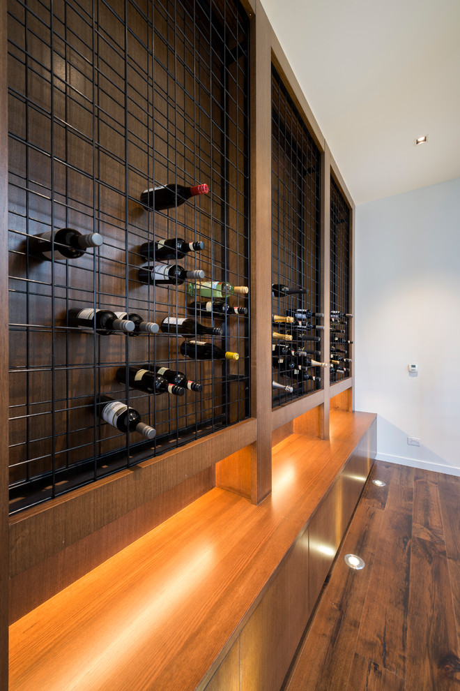 Design ideas for a contemporary wine cellar in Melbourne with orange floor.