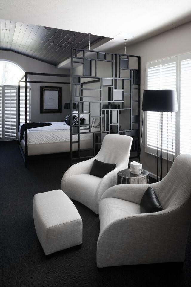 Modern master bedroom in Other with white walls and carpet.