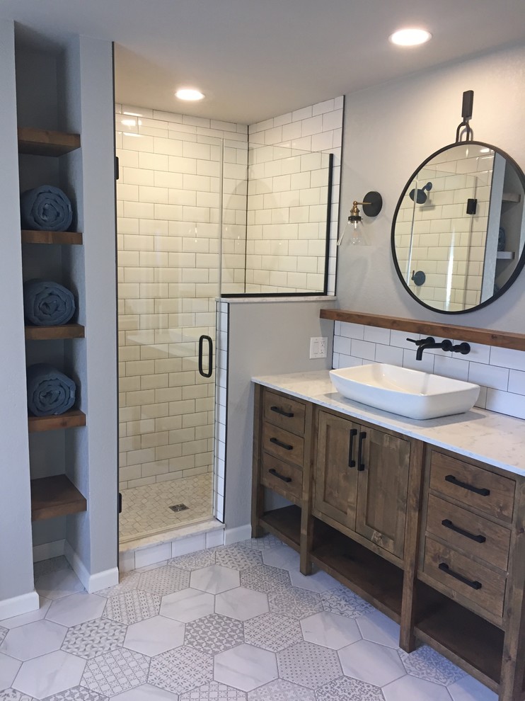 Design ideas for a mid-sized country master bathroom in Oklahoma City with shaker cabinets, medium wood cabinets, a freestanding tub, porcelain floors, a vessel sink, engineered quartz benchtops and white floor.