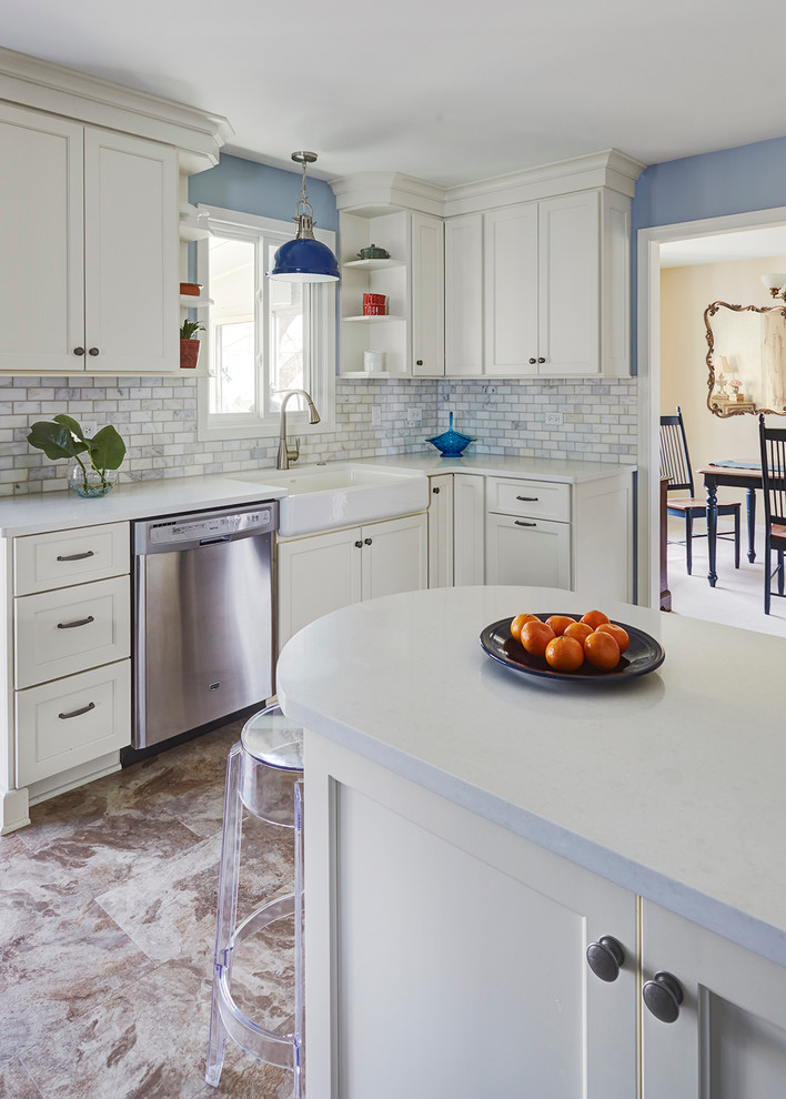 Inspiration for a mid-sized transitional l-shaped separate kitchen in San Francisco with a farmhouse sink, flat-panel cabinets, white cabinets, quartz benchtops, white splashback, stone tile splashback, stainless steel appliances, vinyl floors and a peninsula.