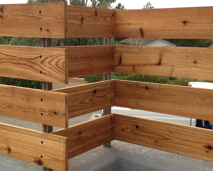 Photo of a mid-sized rustic full sun backyard retaining wall landscape in Denver for summer.