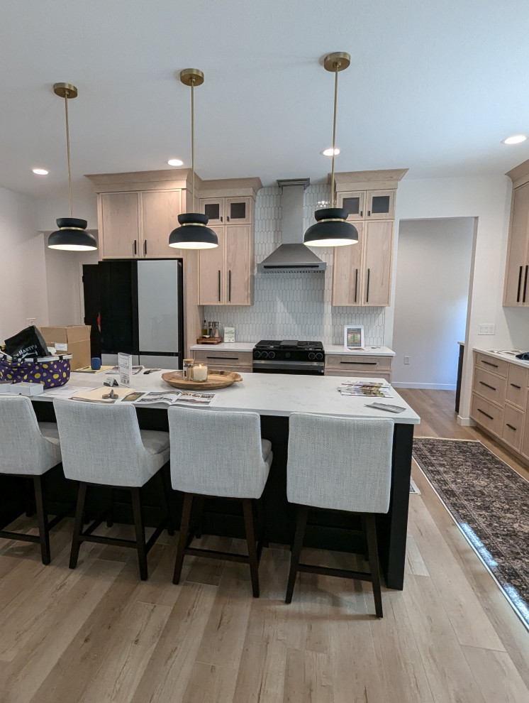 Eat-in kitchen - large transitional l-shaped vinyl floor and brown floor eat-in kitchen idea with a double-bowl sink, shaker cabinets, light wood cabinets, quartzite countertops, white backsplash, ceramic backsplash, stainless steel appliances, an island and white countertops