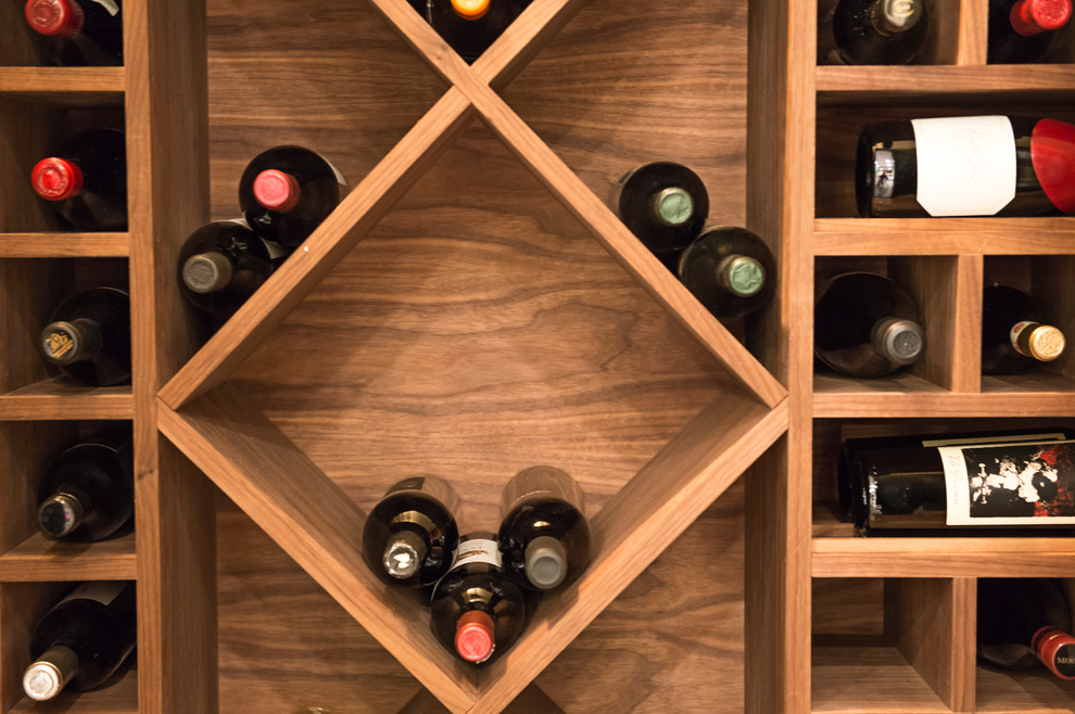 Design ideas for a small contemporary wine cellar in Calgary with light hardwood floors and display racks.