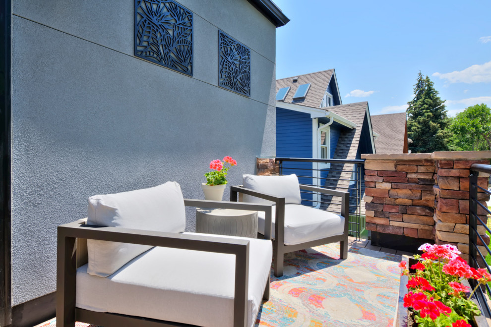 Example of a mid-sized trendy backyard patio design in Denver with a fire pit and a roof extension