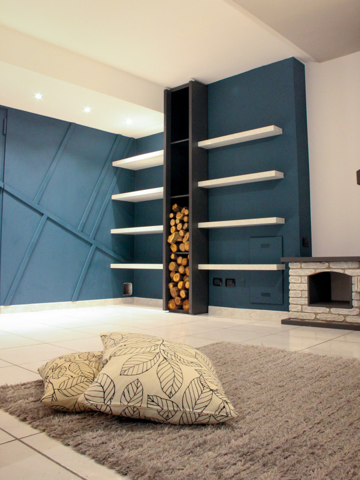 Photo of a mid-sized modern fully buried basement in Milan with ceramic floors, a standard fireplace, a brick fireplace surround, white floor and decorative wall panelling.