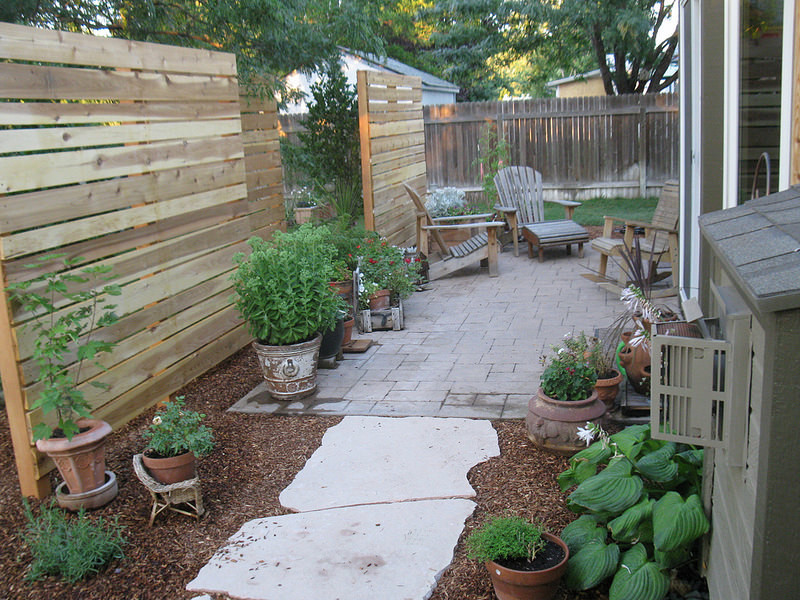 Photo of a mid-sized contemporary backyard shaded formal garden in Boise with natural stone pavers.