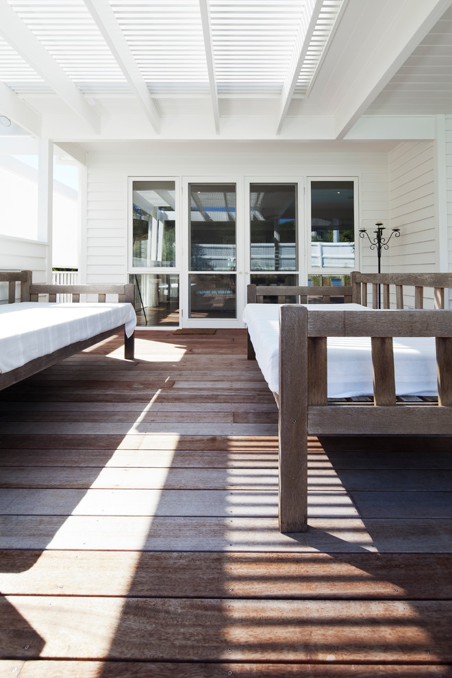 This is an example of a mid-sized beach style white exterior in Melbourne with wood siding.