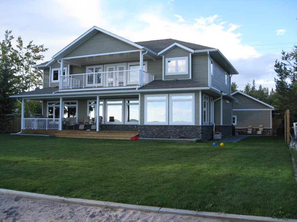 Mid-sized traditional two-storey grey exterior in Calgary with concrete fiberboard siding and a hip roof.