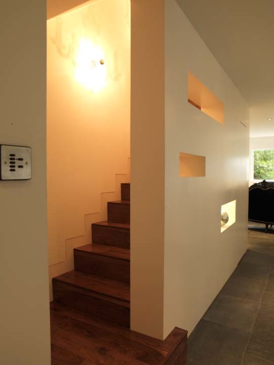 This is an example of a mid-sized contemporary wood straight staircase in London with wood risers.