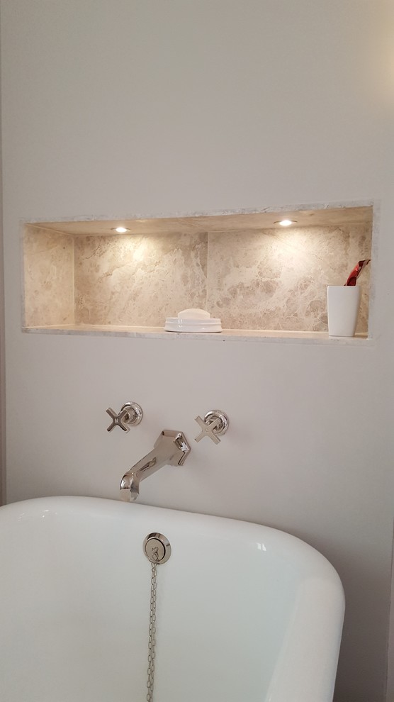 This is an example of a large traditional family bathroom in Other with freestanding cabinets, a freestanding bath, an alcove shower, a wall mounted toilet, grey tiles, stone tiles, grey walls, medium hardwood flooring, a pedestal sink, marble worktops, brown floors and a hinged door.